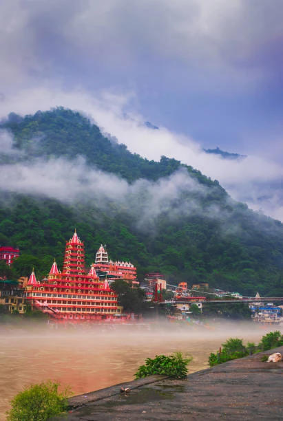 Rishikesh temples beside the Ganga in misty mountain weather